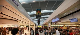 LONDON, ENGLAND - Passengers walk  through the shopping area at terminal five at Heathrow airport.