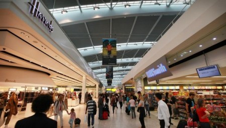 LONDON, ENGLAND - Passengers walk  through the shopping area at terminal five at Heathrow airport.